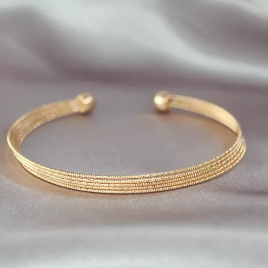 Imagen de Brazalete Semiabierto Cinco Aros Texturizados Dos Esferas Oro Dorado  2005